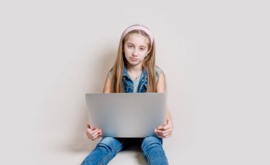 Little girl using laptop computer clipart