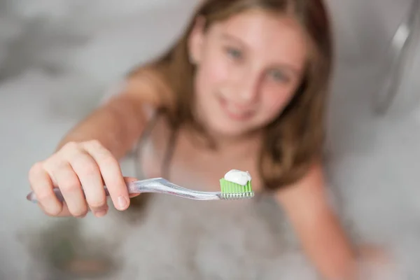 Meninas habd segurando escova de dentes com pasta de dentes — Fotografia de Stock