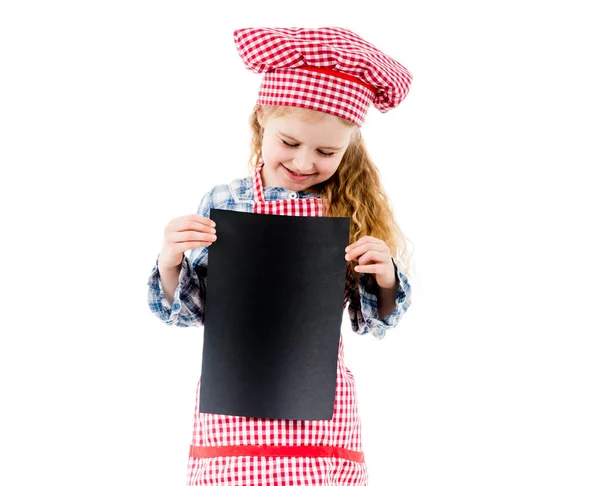 Little chef girl holding piece of paper with free space, isolated — Stock Photo, Image