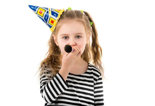 Portrait of little girl blowing in party blower — Stock Photo, Image