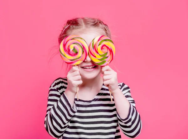 Kid girl with lollypops in front her eyes — Stock Photo, Image
