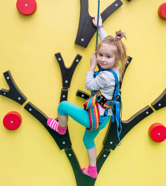 Little girl on childrens climbing wall — Stock Photo, Image