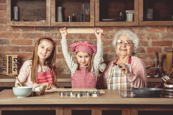 Little grandchilds ready to make cookies with grandmother — Stock Photo, Image