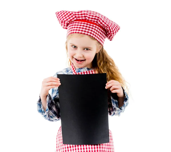 Little girl in chef uniform with blank paper — Stock Photo, Image