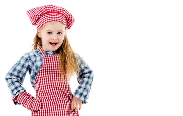 Joyful little girl in red apron isolated on white background — Stock Photo, Image