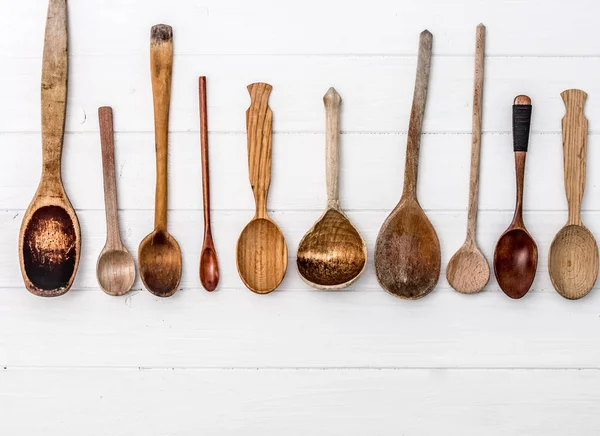 Hand-carved wooden spoons on white baclground — Stock Photo, Image