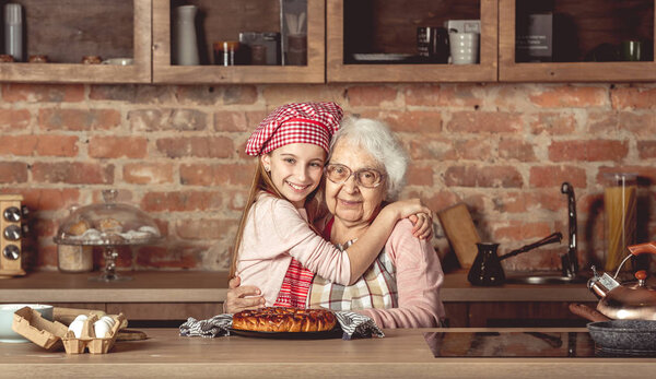 Granddaughter hug her happy grandmother