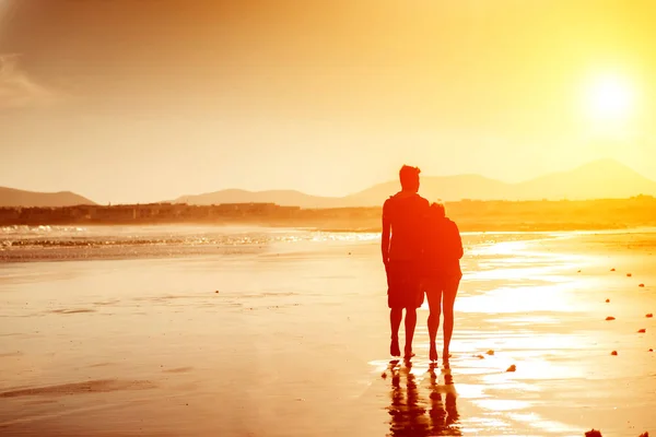 Siluetas de una pareja en la playa —  Fotos de Stock