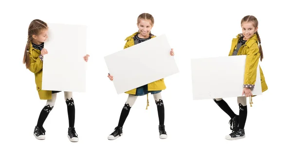 Leende liten flicka med tomt ark i händer — Stockfoto