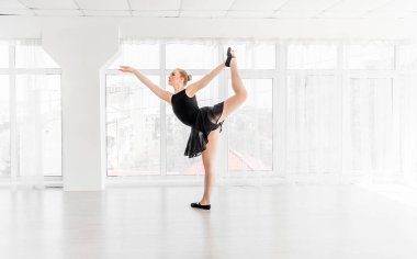 Young ballerina practising ballet moves clipart
