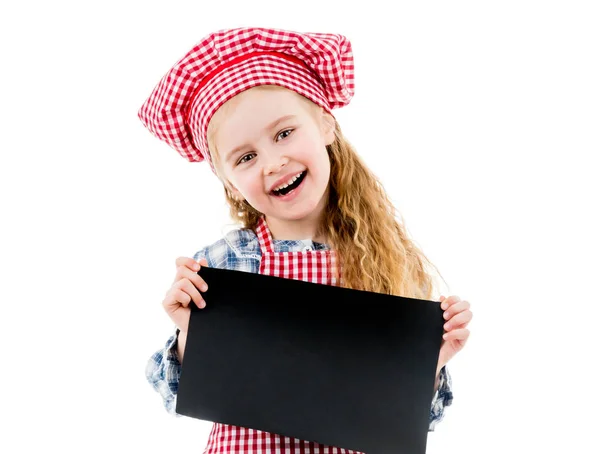 Malá holčička v kuchař jednotný s prázdný papír — Stock fotografie