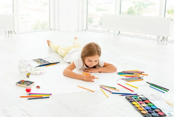 Menina no chão desenho com lápis — Fotografia de Stock