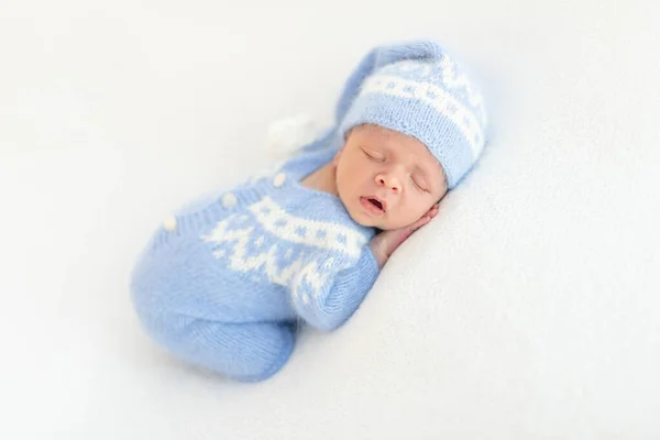 Lovely newborn in knitted suit — Stock Photo, Image