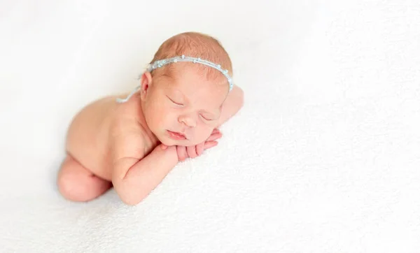 Baby laying on white bedcover — Stock Photo, Image