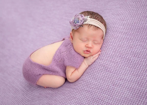 Adorable newborn in knitted suit — Stock Photo, Image