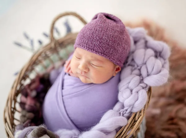 Cute newborn in purple hat — Stock Photo, Image