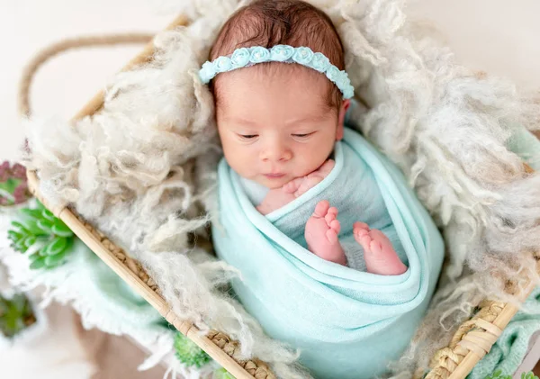 Baby in a knitted green outfit, closeup Stock Photo by ©tan4ikk 141572150