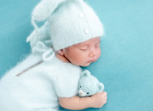 Cute newborn in knitted suit — Stock Photo, Image
