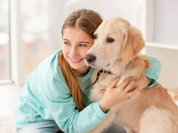 Cute girl cuddling lovely dog — Stok fotoğraf