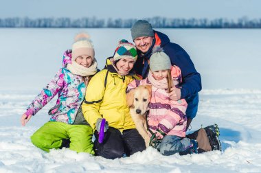 Family with dog on winter walk