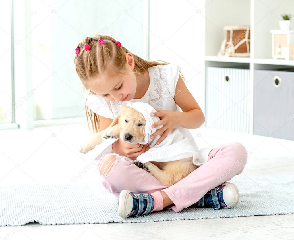 Girl taking care about puppy