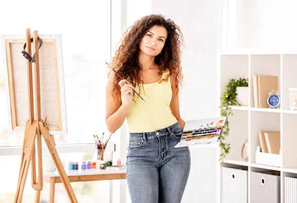 Artista segurando tintas e borlas — Fotografia de Stock