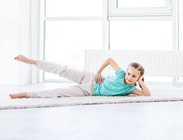 Little girl doing workout — Stock Photo, Image