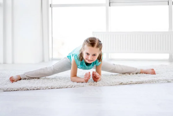 Little gymnast performing twine