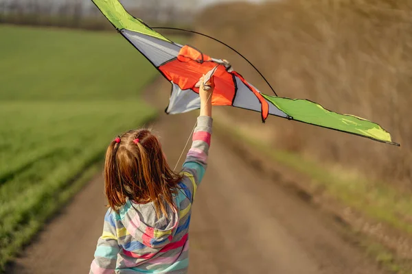 Lovely little girl flying kite — Stock Photo, Image