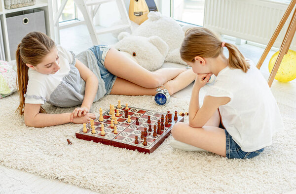 Pretty girls playing chess game
