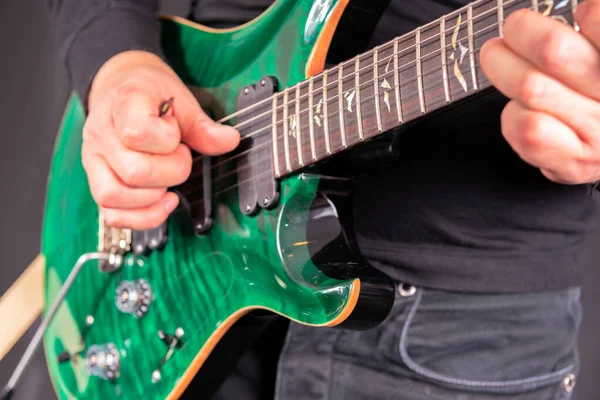 Man's hands playing electric guitar