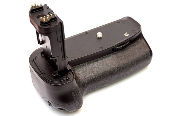 Battery grip for modern DSLR camera isolated on white background.