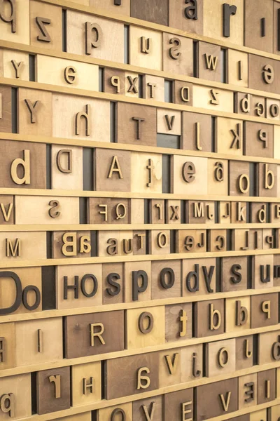 Retro Styled english Alphabet on Wooden Background. toned texture.