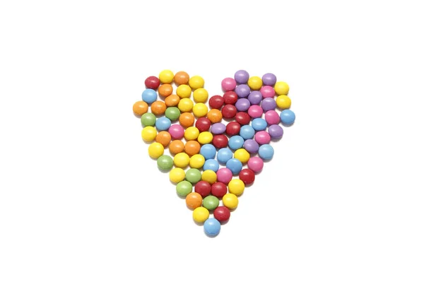 Abstract heart from colored chocolate candy in multicolored glaz — Stock Photo, Image