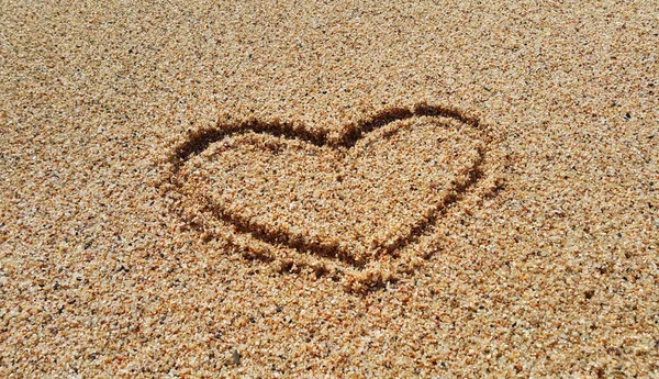 Drawing of abstract heart in the sand background — Stock Photo, Image