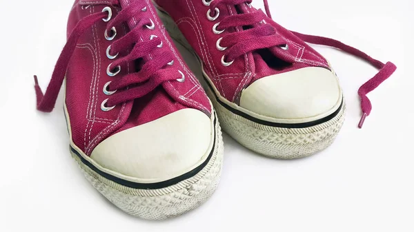 Old crimson sneakers on white background — Stock Photo, Image