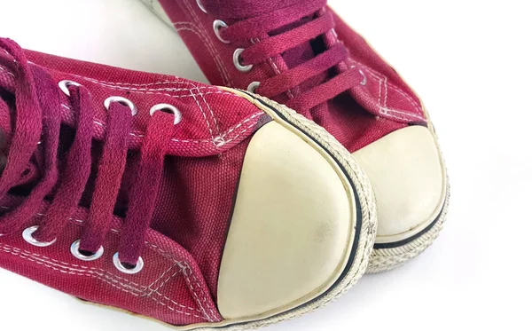 Old wine-colored sneakers on white background — Stock Photo, Image