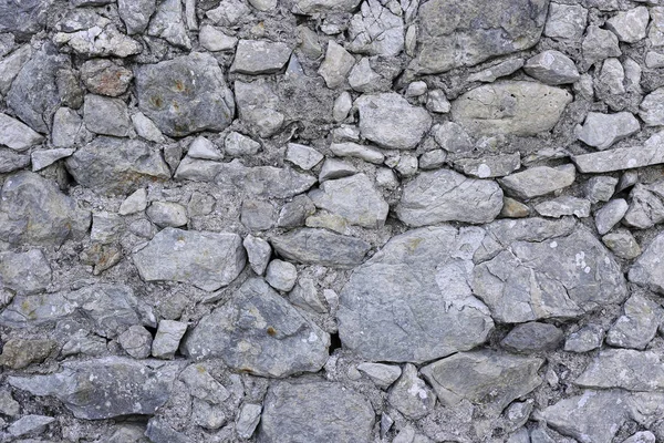 Parede velha de pedras de várias formas — Fotografia de Stock