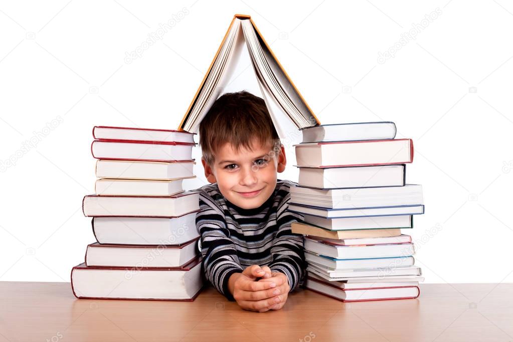 Schoolboy and heap of books