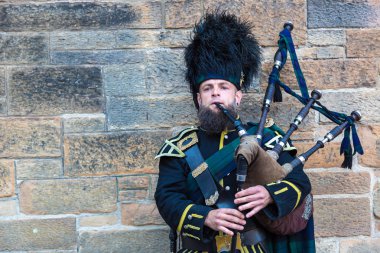 Bagpiper playing music in Edinburgh Castle