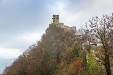 Rocca della Guaita fortress in fog
