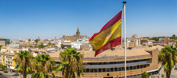 Spain flag and panoramic aerial view of Sevilla