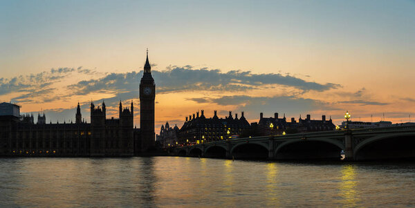 Big Ben near Houses of Parliament and Westminster bridge in London in a beautiful summer night, England, United Kingdom