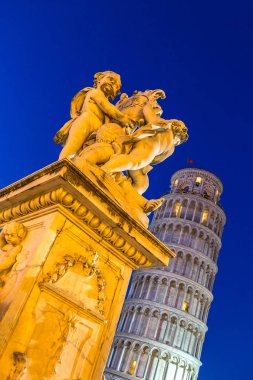 Pisa Kulesi melekler heykeli ile bir yaz günü İtalya'da yaslanmış.