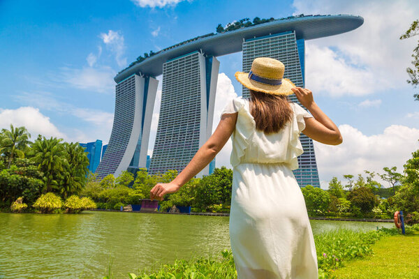 SINGAPORE, SINGAPORE - FEBRUARY 26, 2020: Woman traveler looking at Marina Bay Sands Hotel  in Singapore