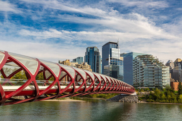CALGARY, CANADA - APRIL 2, 2020: Peace Bridge across Bow river in Calgary in a sunny day, Canada