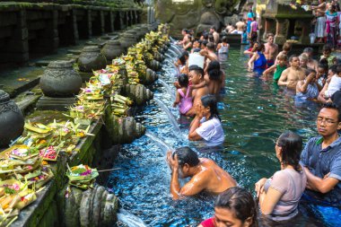 BALI, INDONEZYA - 28 Şubat 2020: Bali halkı Endonezya 'nın Bali kentindeki Pura Tirta Empul Tapınağı' ndaki kutsal havuzda dua ediyor