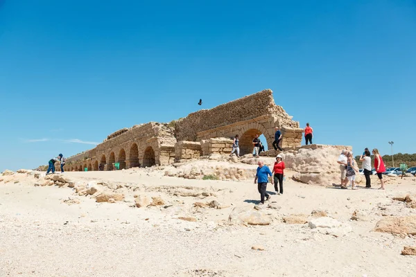 Gente explorando el antiguo acueducto romano en Cesarea, Israel — Foto de Stock