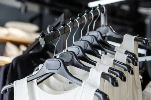 Shirts hanging on a black plastic hangers Stock Picture