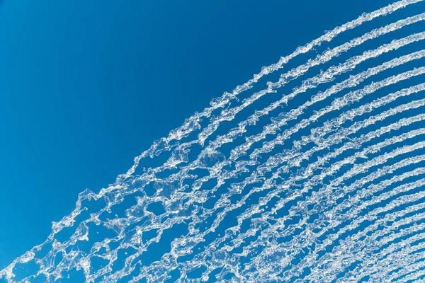 Jatos de água sobre um céu azul — Fotografia de Stock